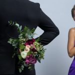 man brings flowers to woman
